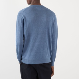 Model wearing NN07 Stone Blue linen crew neck jumper, back view, styled with dark trousers.