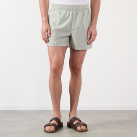 Model wearing NN07 Green Stripe shorts in lightweight fabric with elasticated waist, styled with brown leather sandals