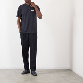 Model wearing NN07 Adam Rope Logo T-Shirt in Deep Navy with black tailored trousers and dark loafers.