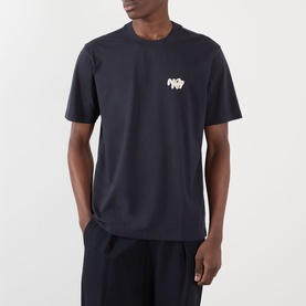 Model wearing NN07 Adam Rope Logo T-Shirt in Deep Navy with crew neck and chest rope logo graphic, styled with matching dark trousers.