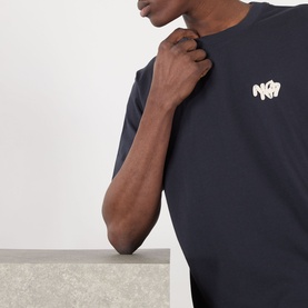 Model wearing NN07 Adam Rope Logo T-Shirt in Deep Navy, featuring crew neck and embroidered rope logo graphic on chest.