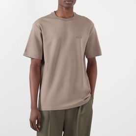 Model wearing NN07 T-Shirt in Clay Mirage, relaxed fit with crew neck and short sleeves, styled with olive trousers.