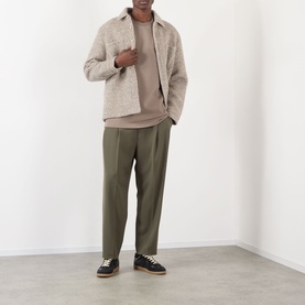Model wearing NN07 Clay Mirage T-Shirt, styled with a beige overshirt, olive trousers, and black trainers.