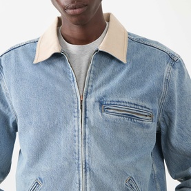 Model wearing Paige Laughlin Acid Wash Denim Jacket in Moby, featuring brushed twill contrast collar, front zip, and chest welt pocket