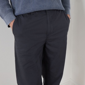 Model wearing Paige Eberton Tapered Leg Trousers in True Navy with elasticated waistband, styled with a blue ribbed knit sweater.