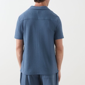 Model wearing Paige Oliver Patch Pocket Casual Shirt in Lakeside blue, rear view, short sleeves, textured pebbled knit fabric, styled with matching