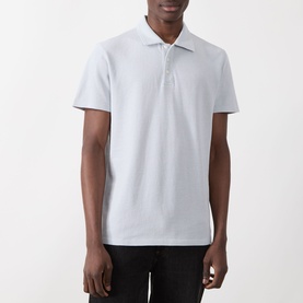 Model wearing Paige Demille Solid Polo Shirt in Bristol Blue Combo, short sleeves, flat collar, piqu&eacute; fabric, with black trousers