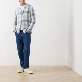 Model wearing Paige Kransey Check Casual Shirt in Shadow Plaid, styled with blue jeans and white trainers.