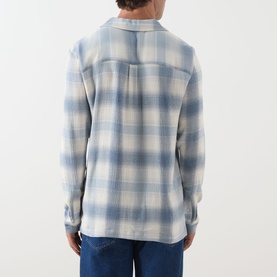 Model wearing Paige Kransey Check Casual Shirt in Shadow Plaid, back view, blue check pattern, styled with dark jeans.