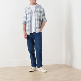 Model wearing Paige Kransey Check Casual Shirt in Shadow Plaid, styled with dark blue jeans and white trainers.