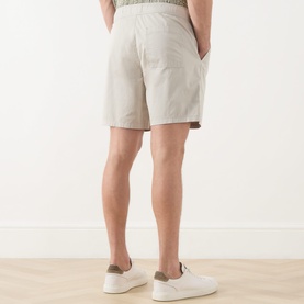 Model wearing Paige shorts in Shallow, rear view, relaxed fit with elasticated waistband, styled with white trainers