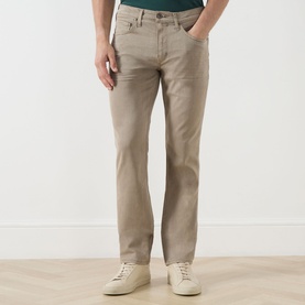 Model wearing Paige Federal Slim Straight Leg Jeans in Vintage Pale Beige, mid rise with contrast stitching, styled with white trainers.