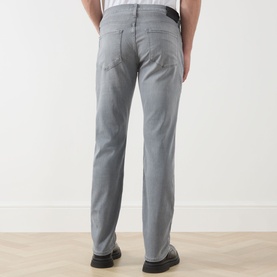 Model wearing Paige Wainwright straight jeans in grey, rear view, styled with black leather shoes.