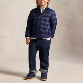 Model wearing Ralph Lauren The Colden Pony Logo Packable Quilted Jacket in Newport Navy, styled with dark jeans and blue boots.