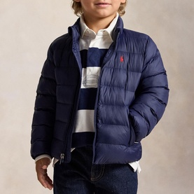 Model wearing Ralph Lauren The Colden Pony Logo Packable Quilted Jacket in Newport Navy, styled with striped jumper and jeans