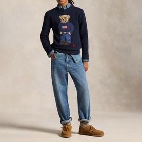 Model wearing Ralph Lauren navy Polo Bear knit jumper with light wash jeans and tan suede boots