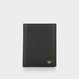 Tom Ford black leather cardholder with gold TF monogram detail, grained texture, bifold design