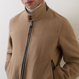 Model wearing Tom Ford Golden Brown virgin wool-silk casual jacket with leather zip trim and button-fastening funnel neck collar.