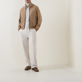Model wearing Tom Ford Golden Brown wool-silk casual jacket with zip front, styled with white trousers and brown loafers
