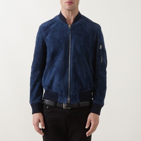 Model wearing Tom Ford indigo suede bomber jacket with silver zip, ribbed collar and cuffs, styled with a black belt.