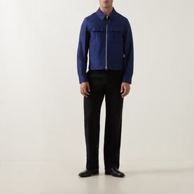 Model wearing Tom Ford navy cotton casual jacket with zip front and chest pockets, styled with black trousers and loafers