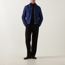 Model wearing Tom Ford navy cotton casual jacket with zip front, styled with black turtleneck and tailored trousers