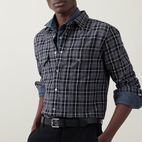 Model wearing Tom Ford grey cotton check casual shirt with rolled sleeves, styled with a denim collar and black belt