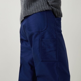 Model wearing Tom Ford Navy Blazer cotton casual trousers with utility pocket detail, styled with a grey knit sweater.