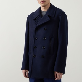 Model wearing Tom Ford navy wool peacoat with double-breasted button front and wide lapels.