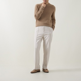 Model wearing Tom Ford Light Taupe cashmere crew neck jumper, styled with white tailored trousers and tan loafers.