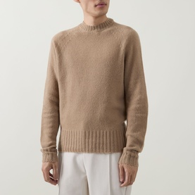 Model wearing Tom Ford Light Taupe cashmere crew neck jumper with ribbed cuffs and hem, styled with white trousers