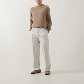 Model wearing Tom Ford Light Taupe cashmere crew neck jumper, styled with white wide-leg trousers and tan loafers.