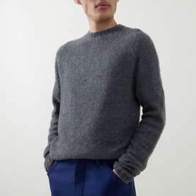 Model wearing Tom Ford Charcoal Cashmere Knit Sweater with crew neckline and ribbed trims, styled with navy trousers