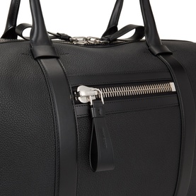 Tom Ford black calf leather hold all with silver-tone zip detail and twin top handles, close-up of front zip pocket