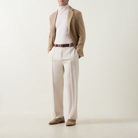 Model wearing Tom Ford camel wool-silk blazer with cream rollneck, tailored trousers, brown leather belt and suede loafers.