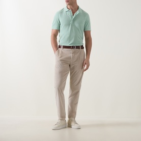 Model wearing Tom Ford Pique Regular Fit Polo Shirt in Light Green, styled with stone chinos, brown belt and white trainers