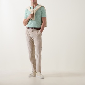 Model wearing Tom Ford Light Green Pique Regular Fit Polo Shirt, styled with beige chinos, brown belt and white trainers