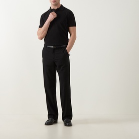 Model wearing Tom Ford black cotton polo shirt, styled with black straight-leg trousers and leather belt.