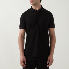 Model wearing Tom Ford black cotton polo shirt with short sleeves and three-button placket.