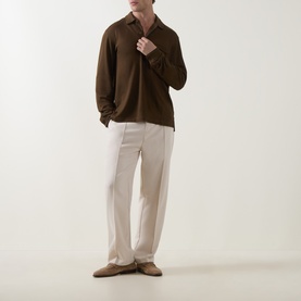 Model wearing Tom Ford brown silk-cotton polo shirt with open collar, styled with cream tailored trousers and suede loafers.