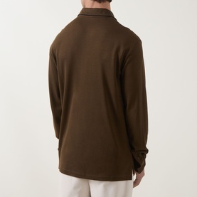 Model wearing Tom Ford brown silk-cotton long-sleeve polo shirt, back view, styled with cream trousers