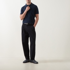 Model wearing Tom Ford Pique Regular Fit Polo Shirt in navy with black tailored trousers and black leather loafers.