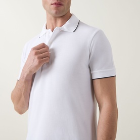 Model wearing Tom Ford white and black polo shirt, short sleeves with contrast tipping detail at collar and cuffs
