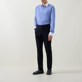 Model wearing Tom Ford Stripe Contrast Shirt in combo blue and white with black slim-fit trousers and dark loafers.