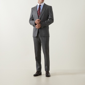 Model wearing Tom Ford grey wool suit with blue shirt, red striped tie, and dark brown Oxford shoes.