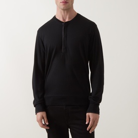 Model wearing Tom Ford black long-sleeve Henley T-shirt in wool, silk and cashmere blend, styled with black trousers.