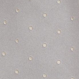 Light grey fabric with scattered cream embroidered circle dot pattern, close-up texture detail shot