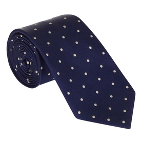 Navy blue silk tie with white polka dot pattern, rolled and displayed upright showing full width and blade detail