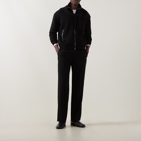 Model wearing Tom Ford black wool zip-through knit with leather patches, styled with black trousers and black leather shoes.
