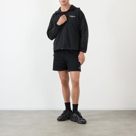 Model wearing 247 Jet Black Casual Jacket with matching black shorts and chunky black trainers.